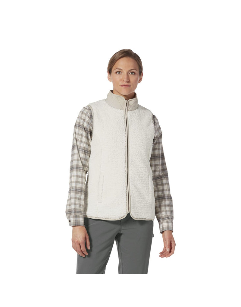Woman wearing Royal Robbins Women's Urbanesque Vest in creme colour, zipped up over a plaid shirt, front view