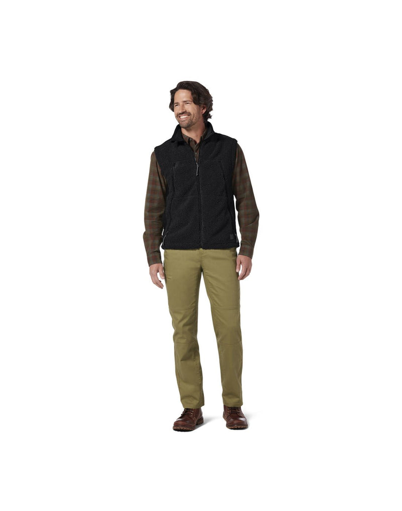 Man wearing Royal Robbins Men's Outerzone Fleece Vest in jet black over a plaid shirt, zipped up, front view
